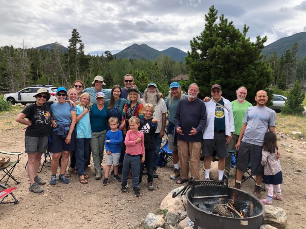 family camp group near campfire