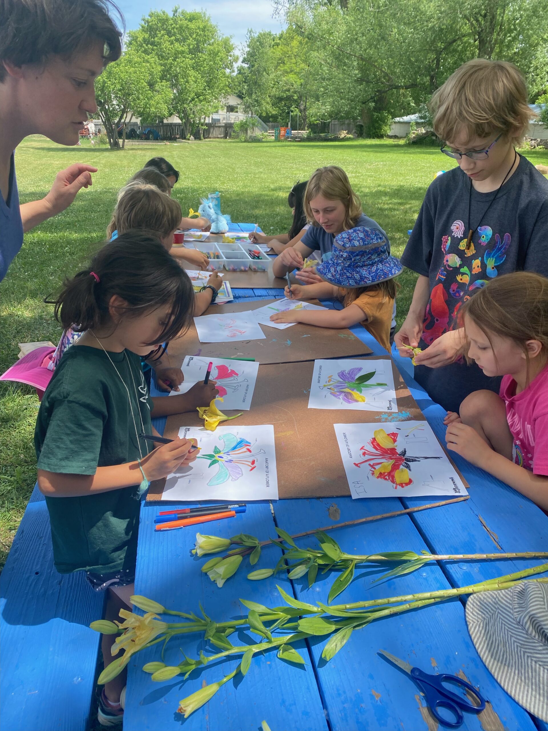 kids at a picnic table doing crafts