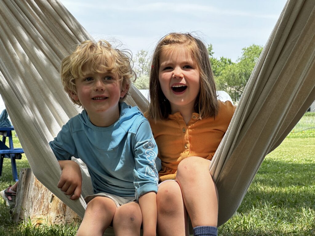 2 kids on a sunny day on a hammock